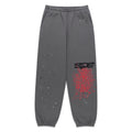 Gray cotton fleece sweatpants with red "SP5DER" and web print, scattered white stars.