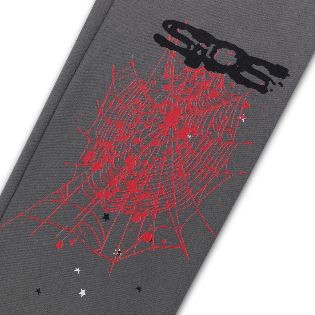 Gray fleece sweatpant with red web, black 'SP5DER' puff print, and scattered stars.