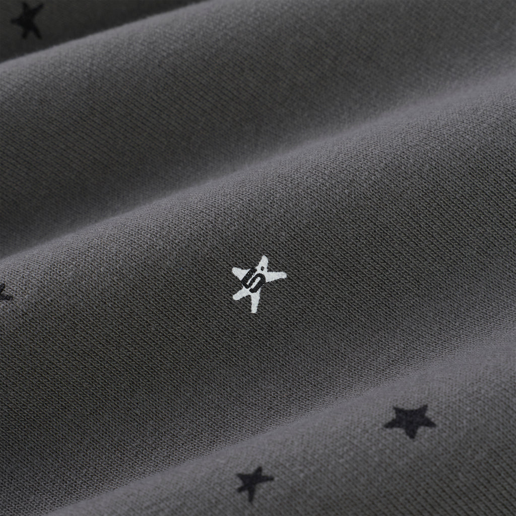 Dark gray 100% cotton fleece sweatpants with white puff print 'SP5DER' star and scattered black stars.