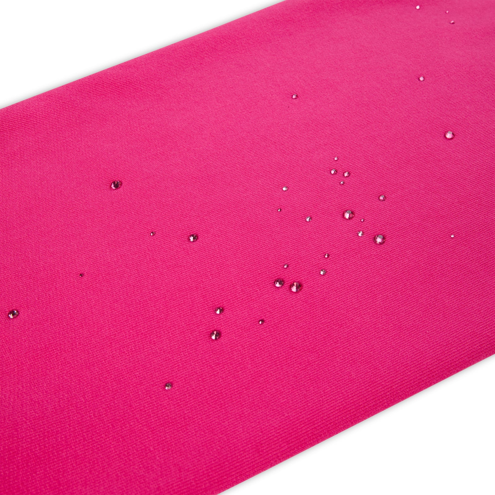 Close-up of a vibrant pink fabric with scattered water droplets, showcasing its water-resistant texture.