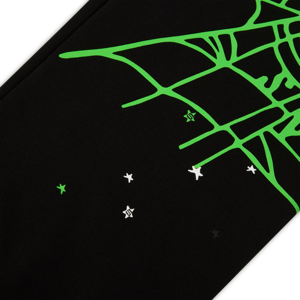 Black 13oz cotton fleece sweatpants with a bright green SP5DER web graphic and scattered white stars.