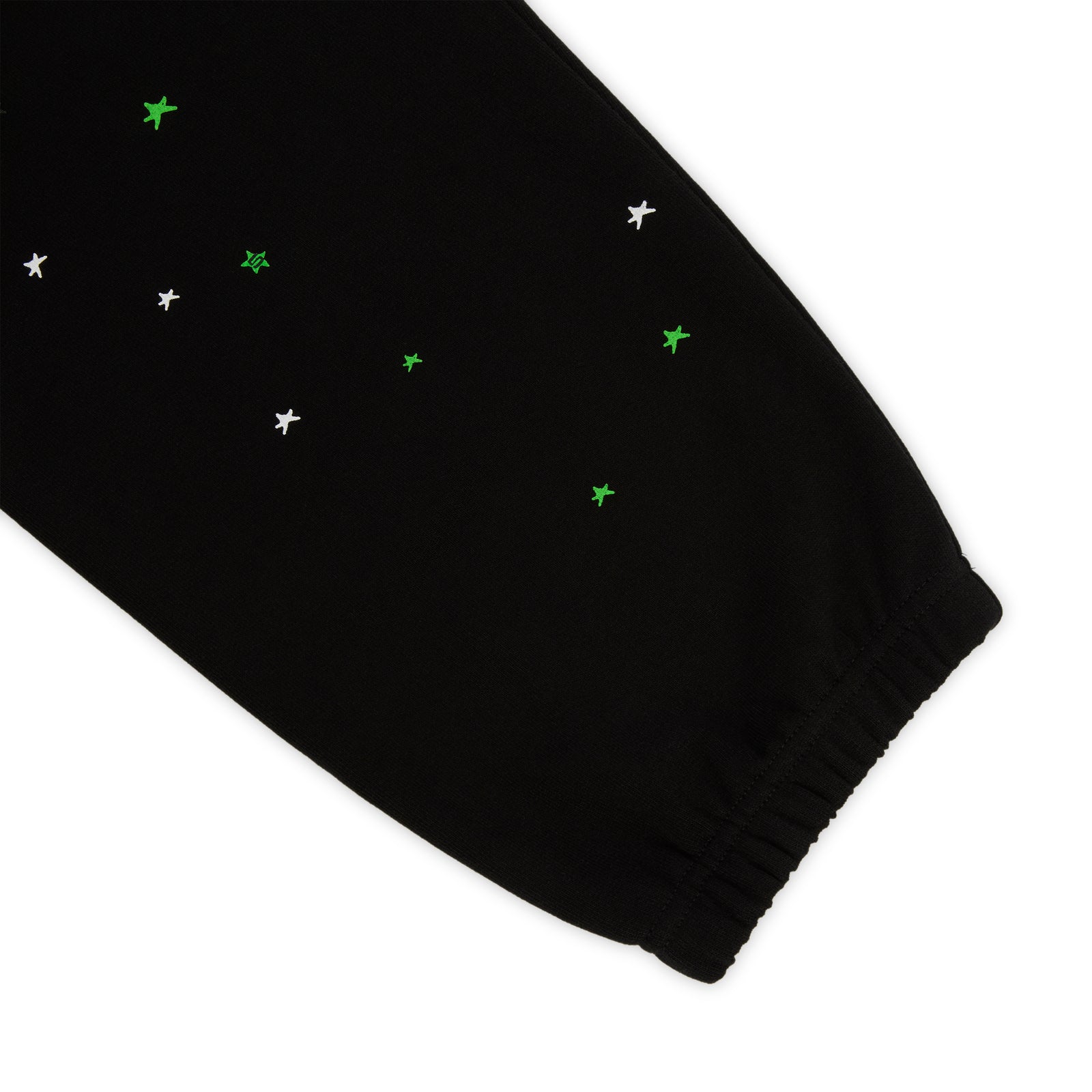 Black HEAVY WEB SWEATPANT with scattered white and green star print, elasticized cuff.