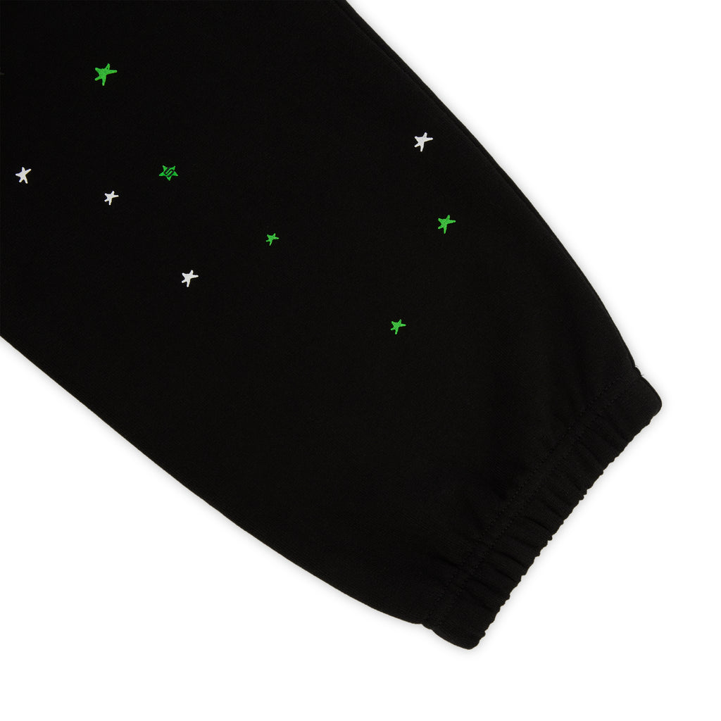 Black HEAVY WEB SWEATPANT with scattered white and green star print, elasticized cuff.