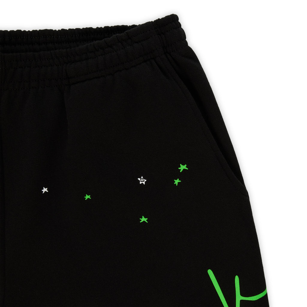 Black 13oz cotton fleece sweatpants with green SP5DER web graphic and scattered white/green stars.