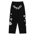 Black cotton fleece sweatpants with reflective "SP5DER" text at crotch and star/5 designs.