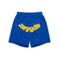 Blue cotton fleece sweatshorts with yellow "SP5DER" text and white star print, raw hem.