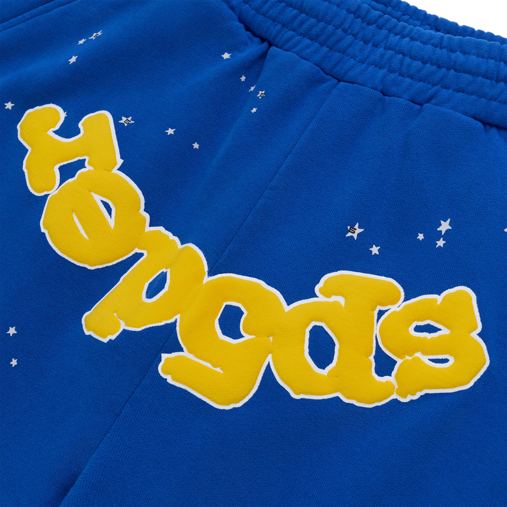 Blue cotton fleece sweatshorts with yellow "SP5DER" text and white star print, elastic waistband.
