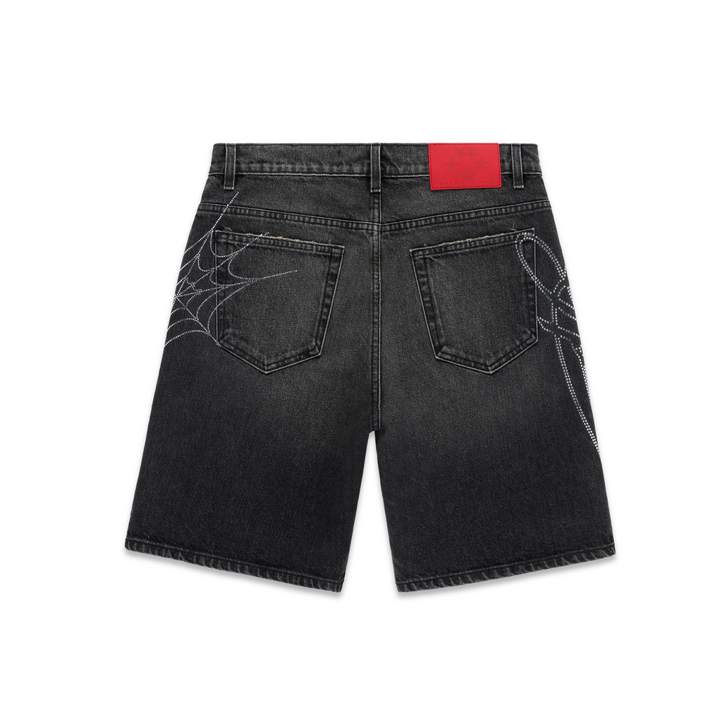 Vintage wash black denim shorts with rhinestone spiderweb design and red leather patch.