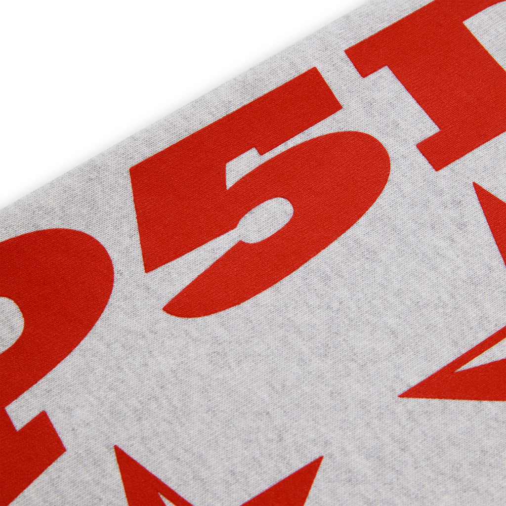 Close-up of a light grey 100% cotton fleece hoodie sleeve with bold red "5P1" and star print.