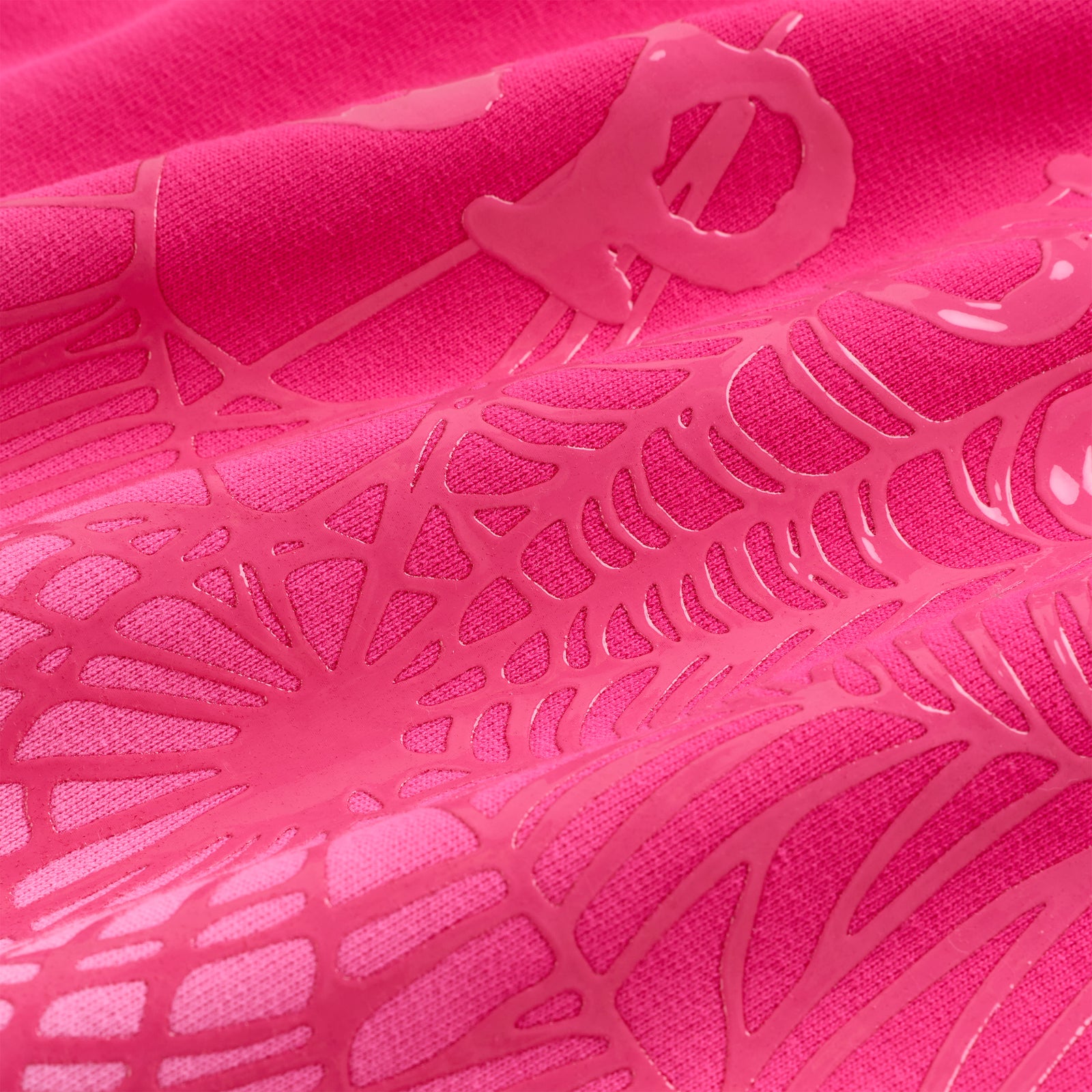 Close-up of a vibrant pink OG Web Ombre Hoodie with puff print spiderweb design on 100% cotton fleece.