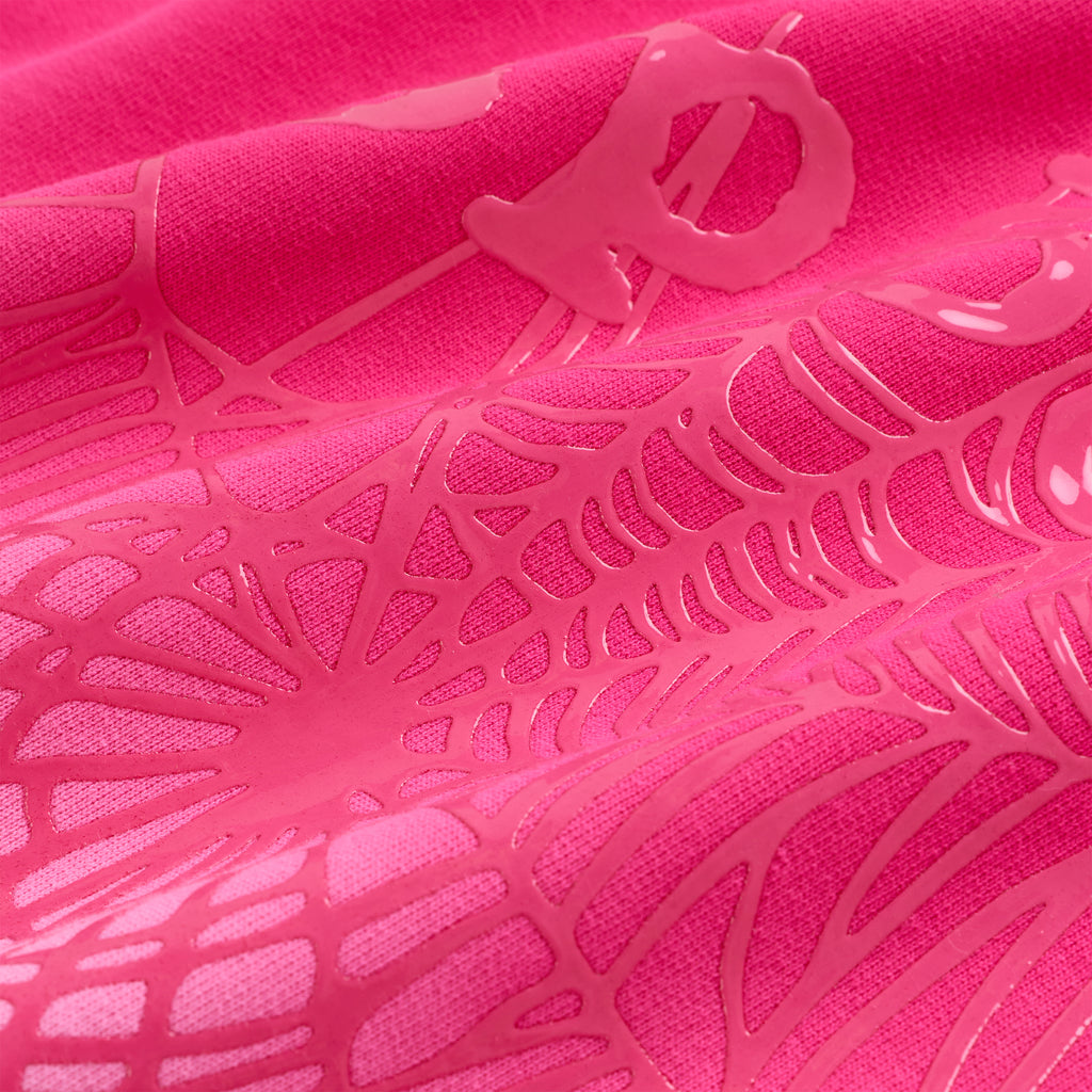 Close-up of a vibrant pink OG Web Ombre Hoodie with puff print spiderweb design on 100% cotton fleece.