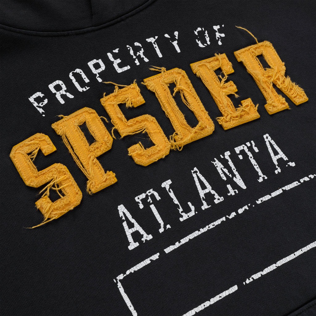 Black cotton fleece hoodie with raised, frayed yellow "SPSDER" lettering and faded white "PROPERTY OF ATLANTA" print.
