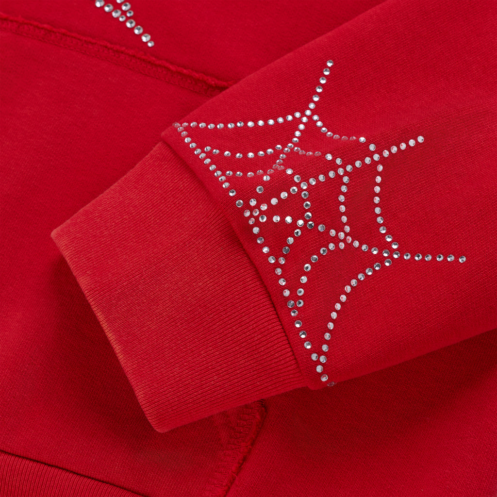 Red cotton fleece hoodie sleeve with rhinestone spider web and ribbed cuff.