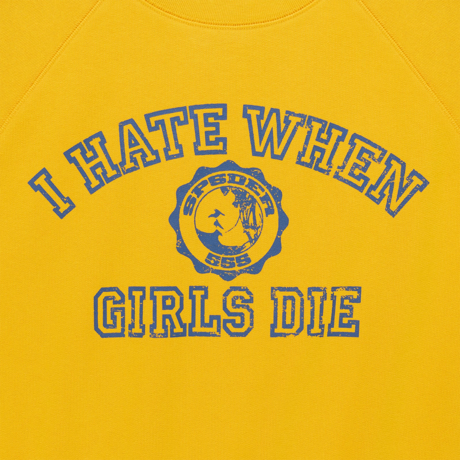 Yellow 100% cotton raglan crewneck featuring a distressed blue graphic print with text and a circular emblem.