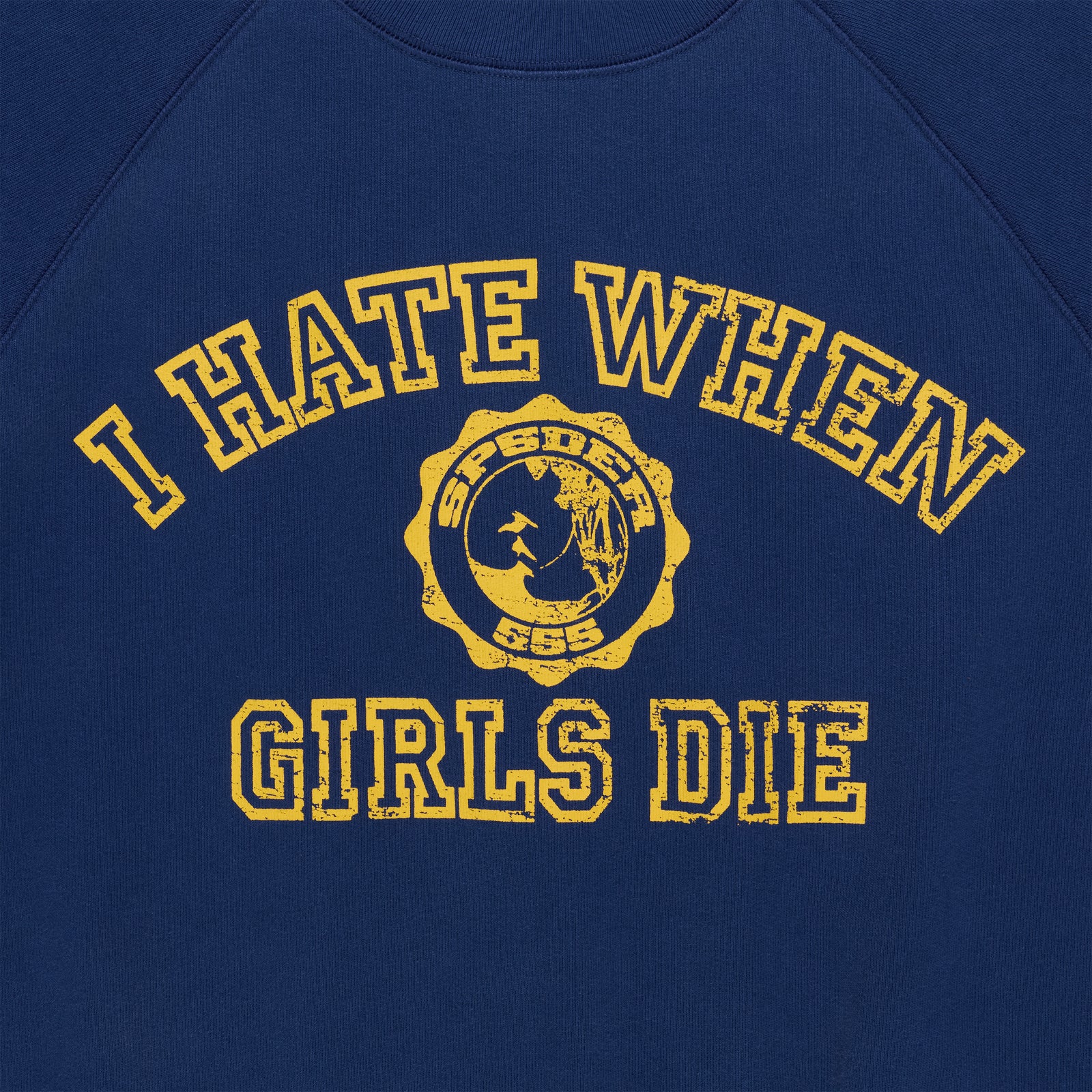 Navy blue 100% cotton raglan crewneck featuring a distressed yellow graphic print with text and a circular emblem.