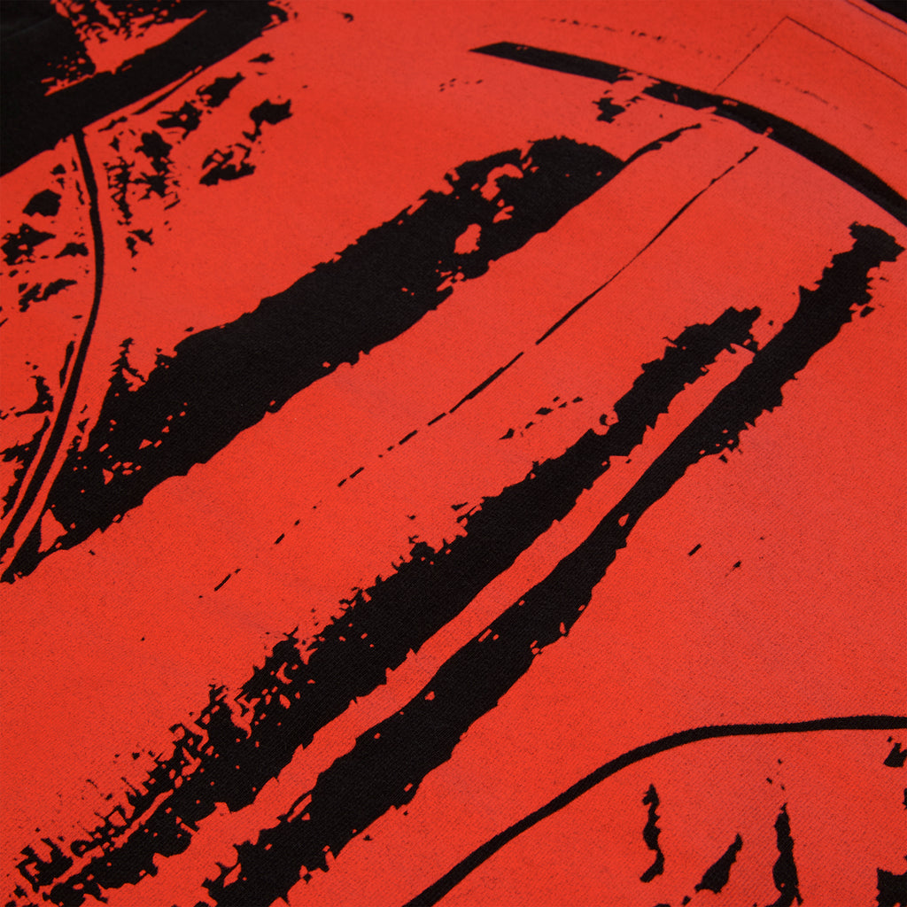 Close-up of a red 13oz cotton fleece JP5 Moto Hoodie with black painted moto design.