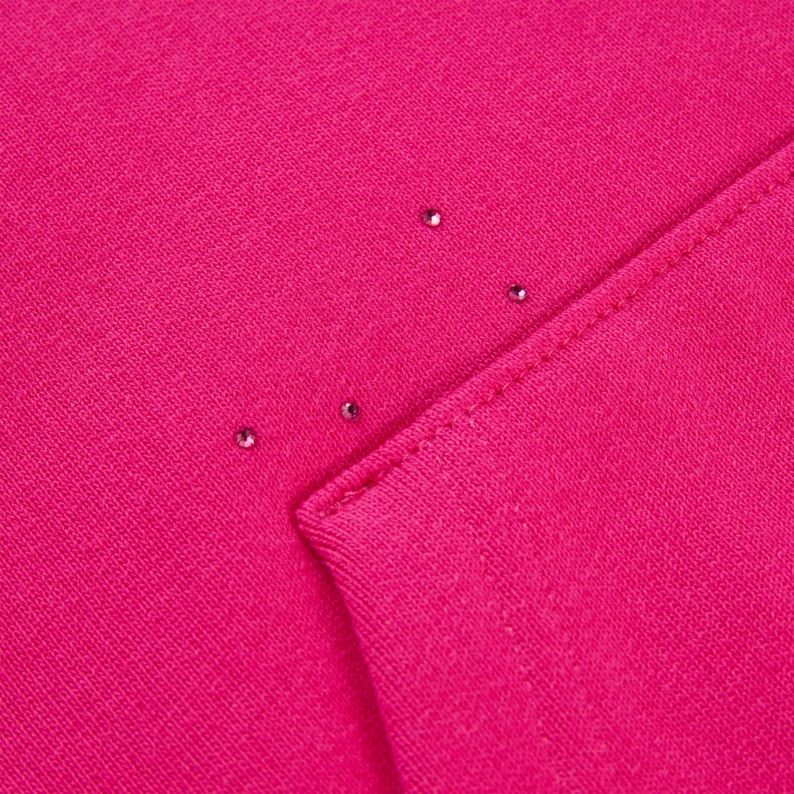 Close-up of a vibrant pink cotton fleece hoodie with scattered rhinestones.