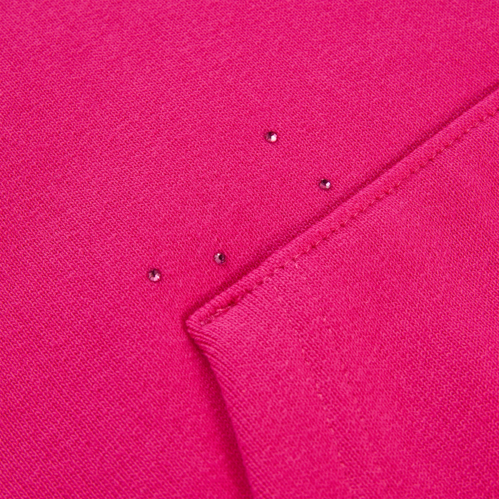 Close-up of a vibrant pink cotton fleece hoodie with scattered rhinestones.