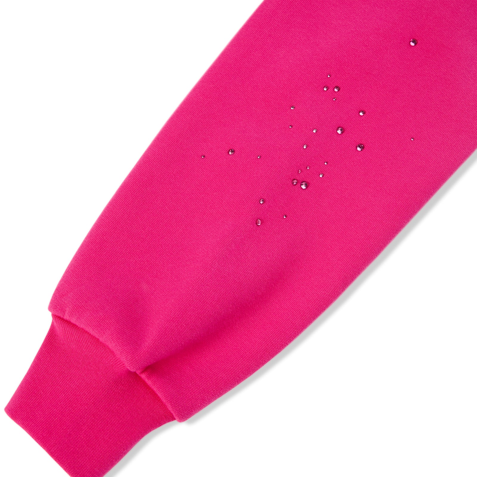Close-up of a vibrant pink cotton fleece hoodie sleeve with water-repellent droplets.