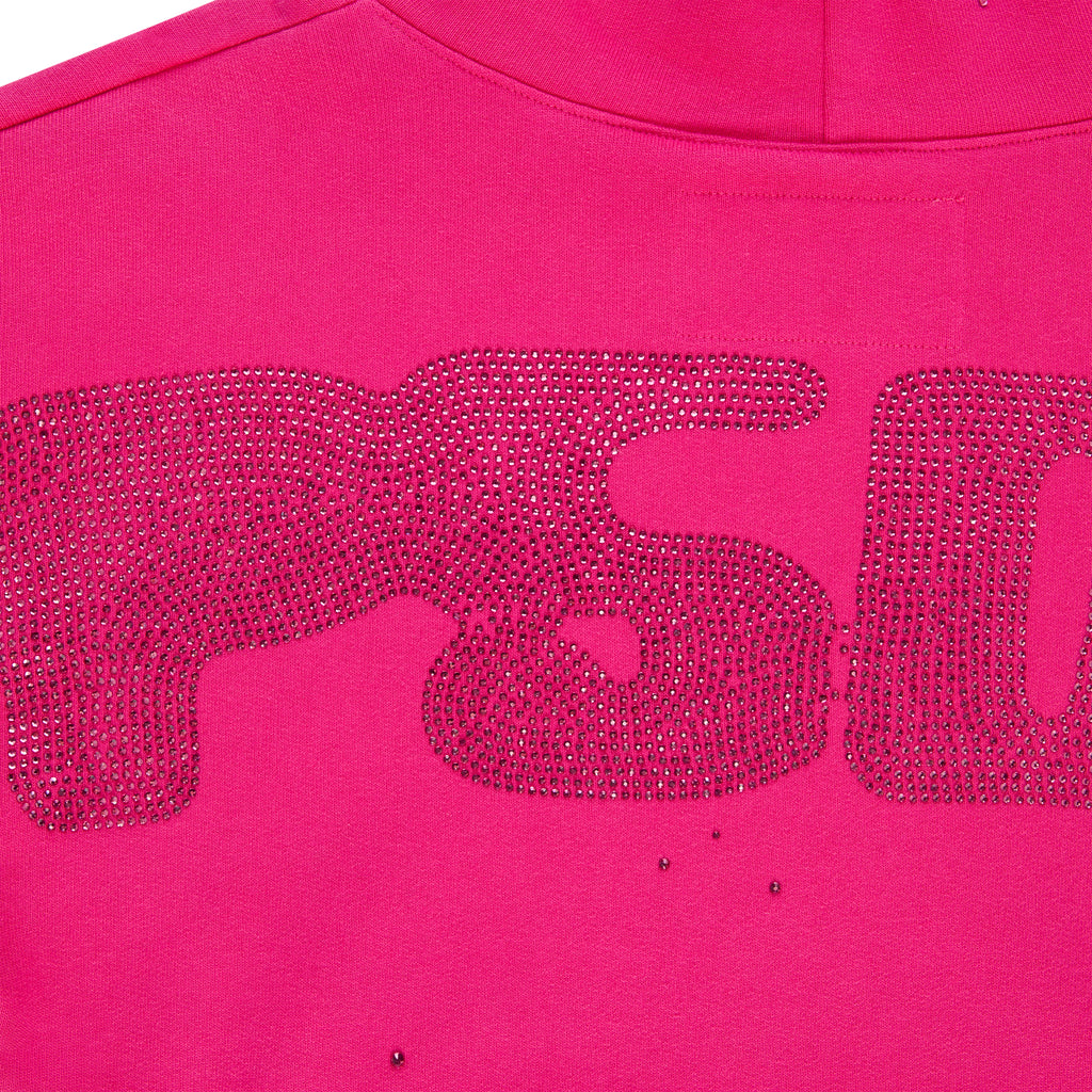 Close-up of a vibrant pink cotton fleece hoodie with a rhinestone design.