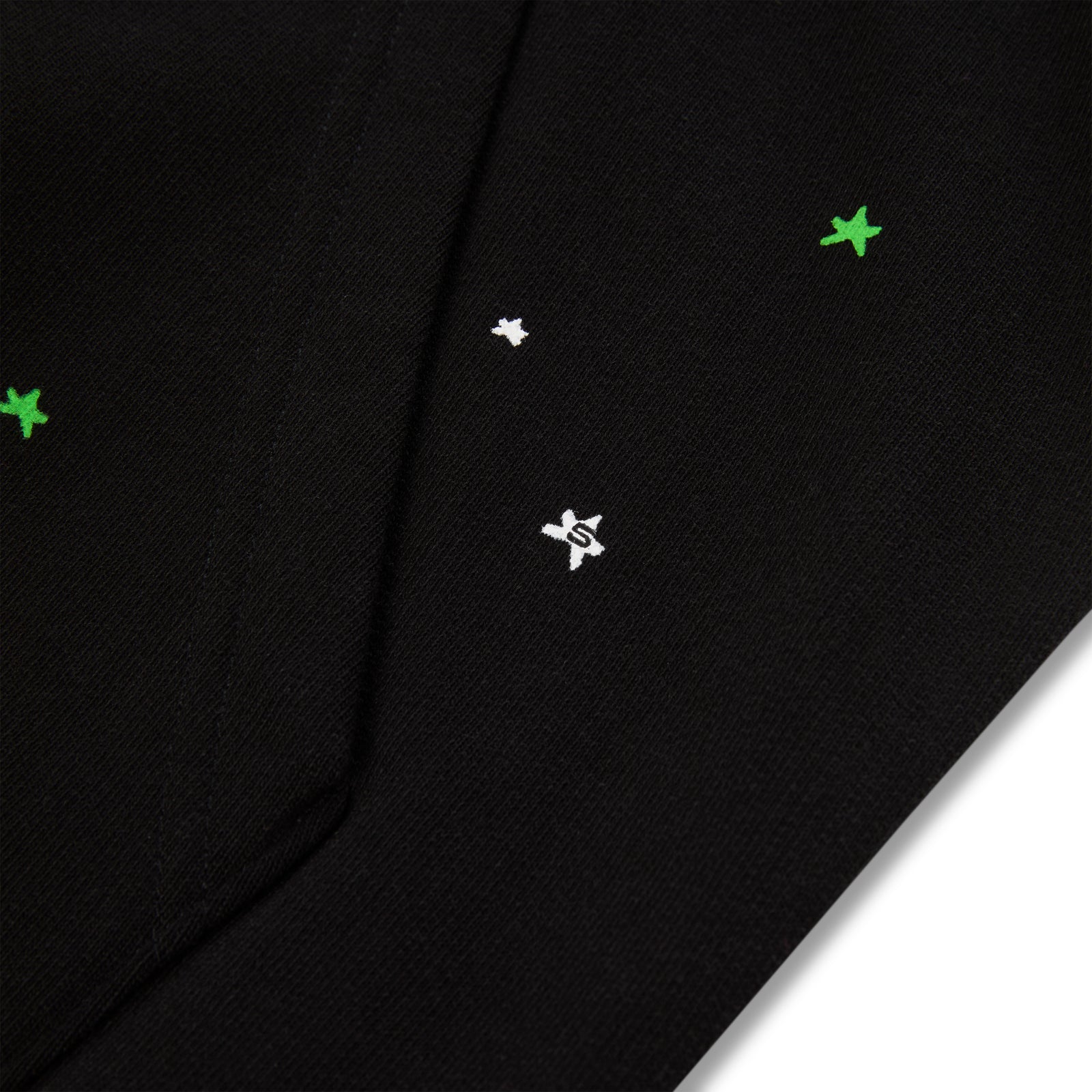 Black heavy web hoodie with scattered green and white star puff prints.