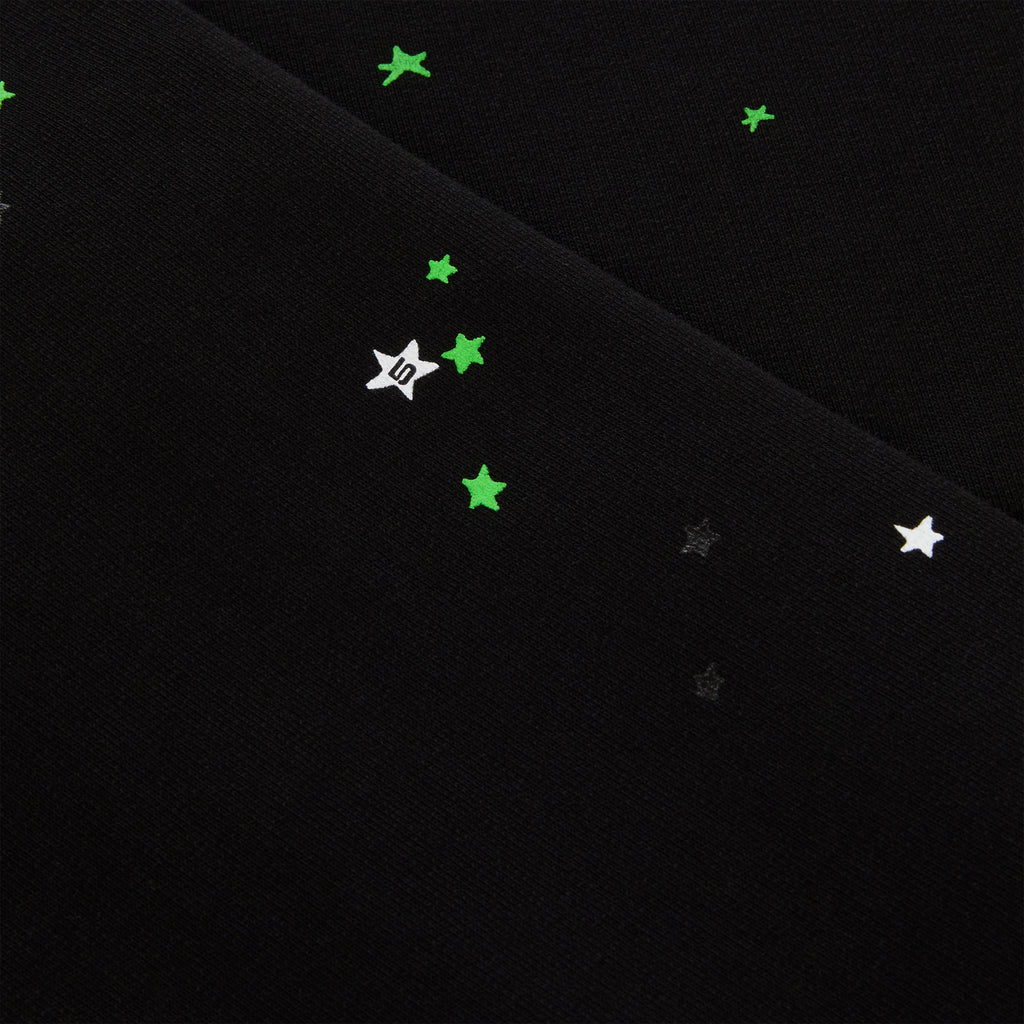 Black heavy web hoodie with scattered green and white star puff prints.