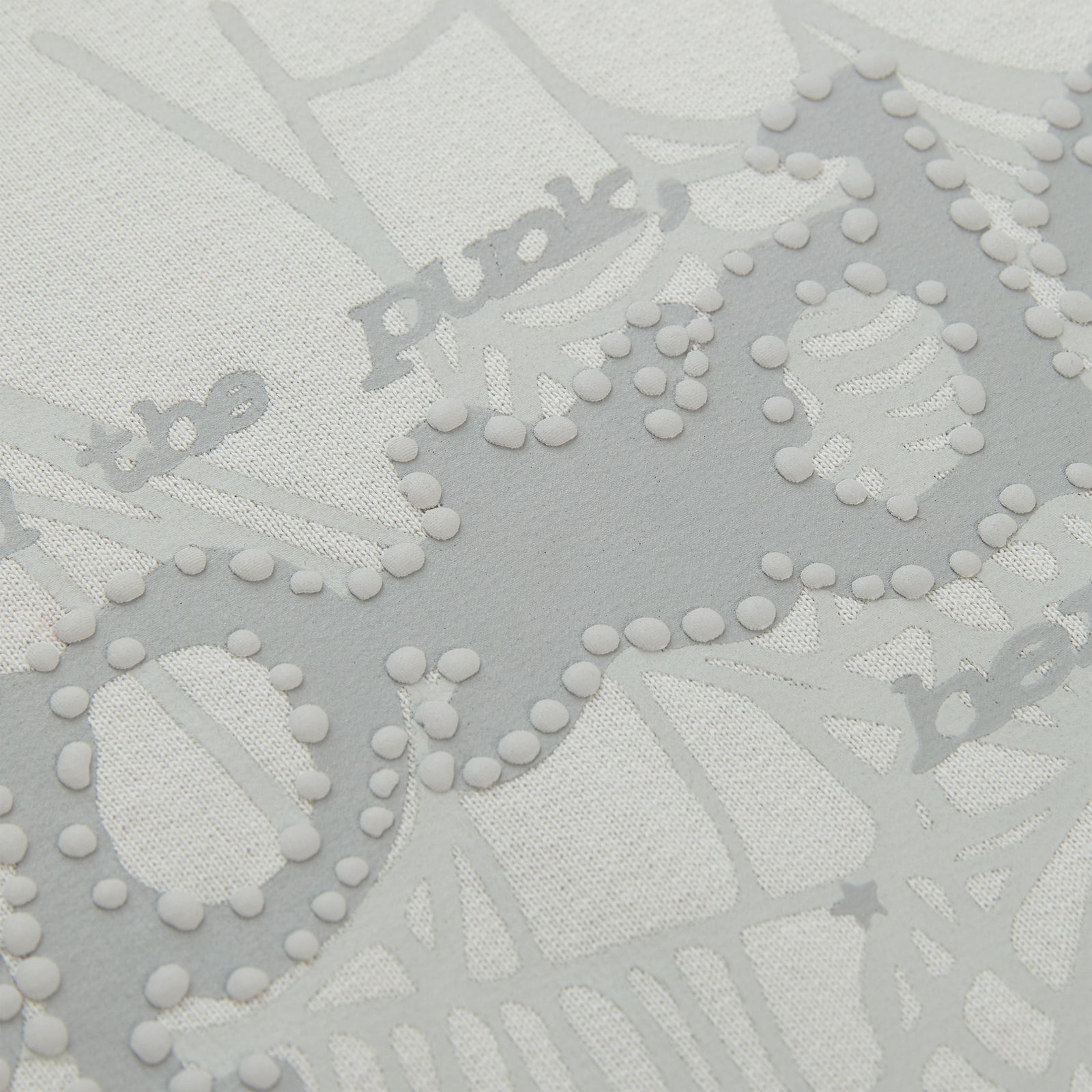Close-up of a white cotton fleece hoodie with gray puff print "Punk" text and spider web design.