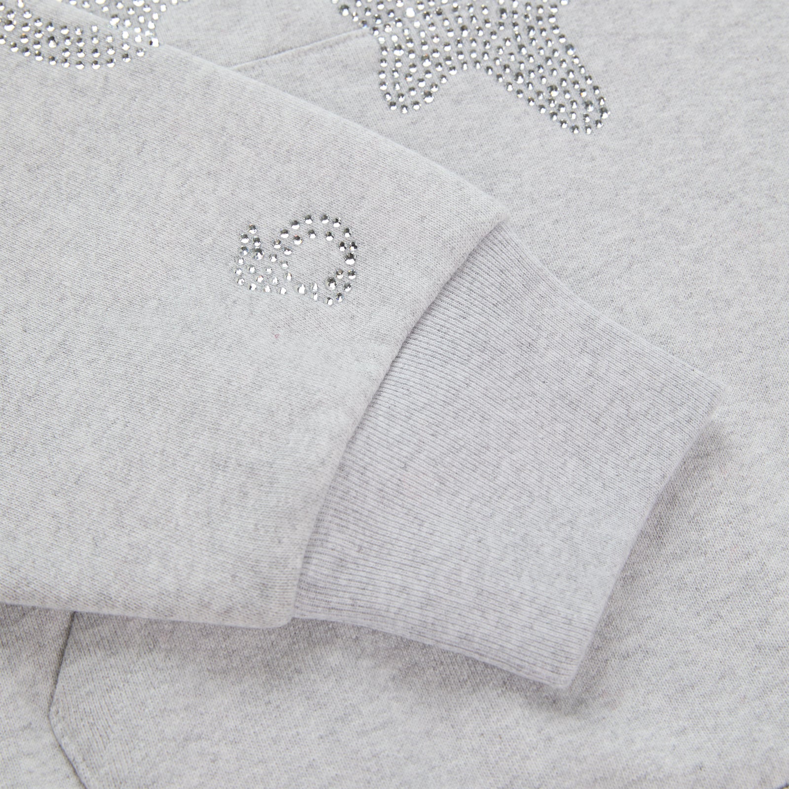 Light grey cotton fleece hoodie with rhinestone 'SP5DER' and star design on sleeve.