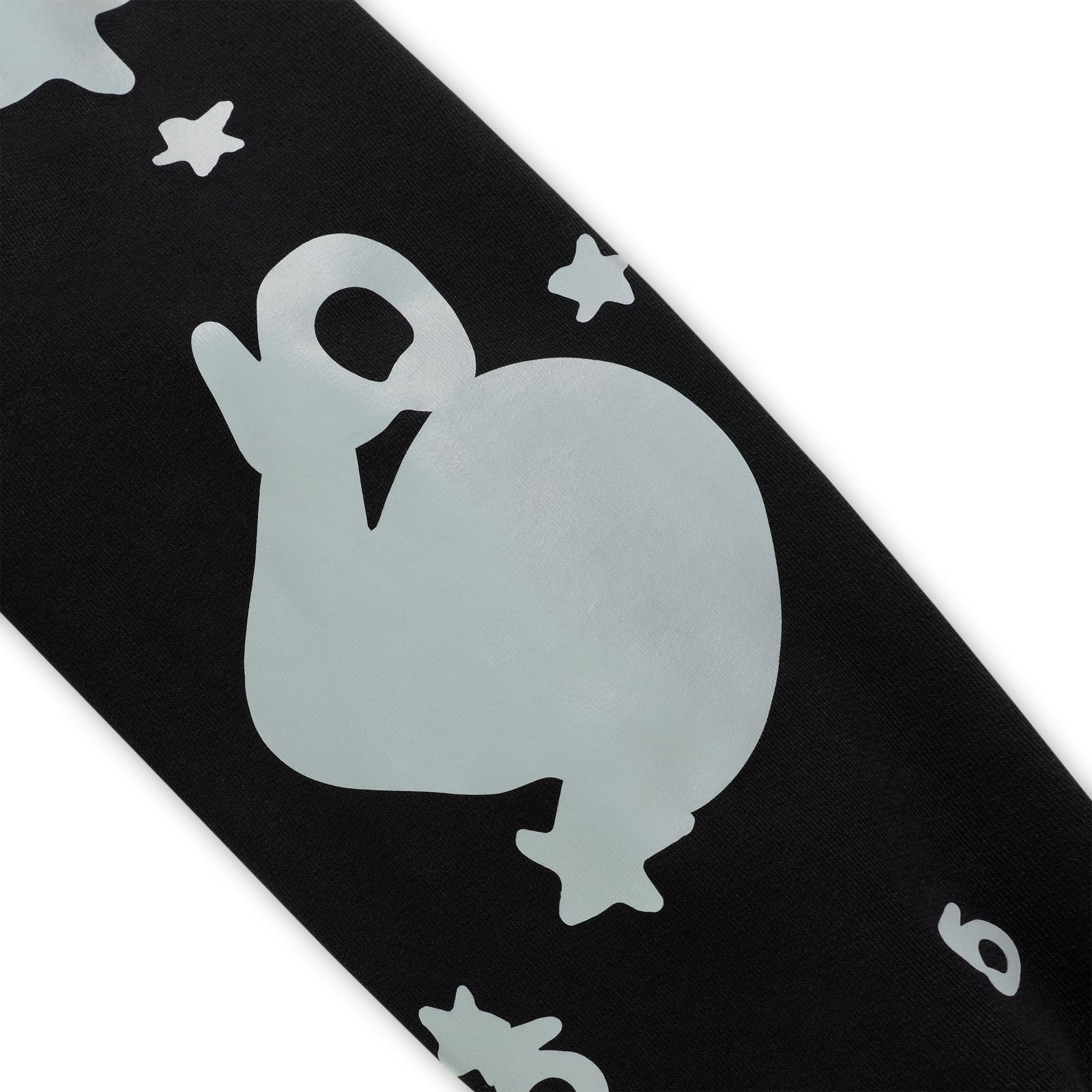 Black cotton fleece hoodie sleeve with reflective beluga whale and star print.