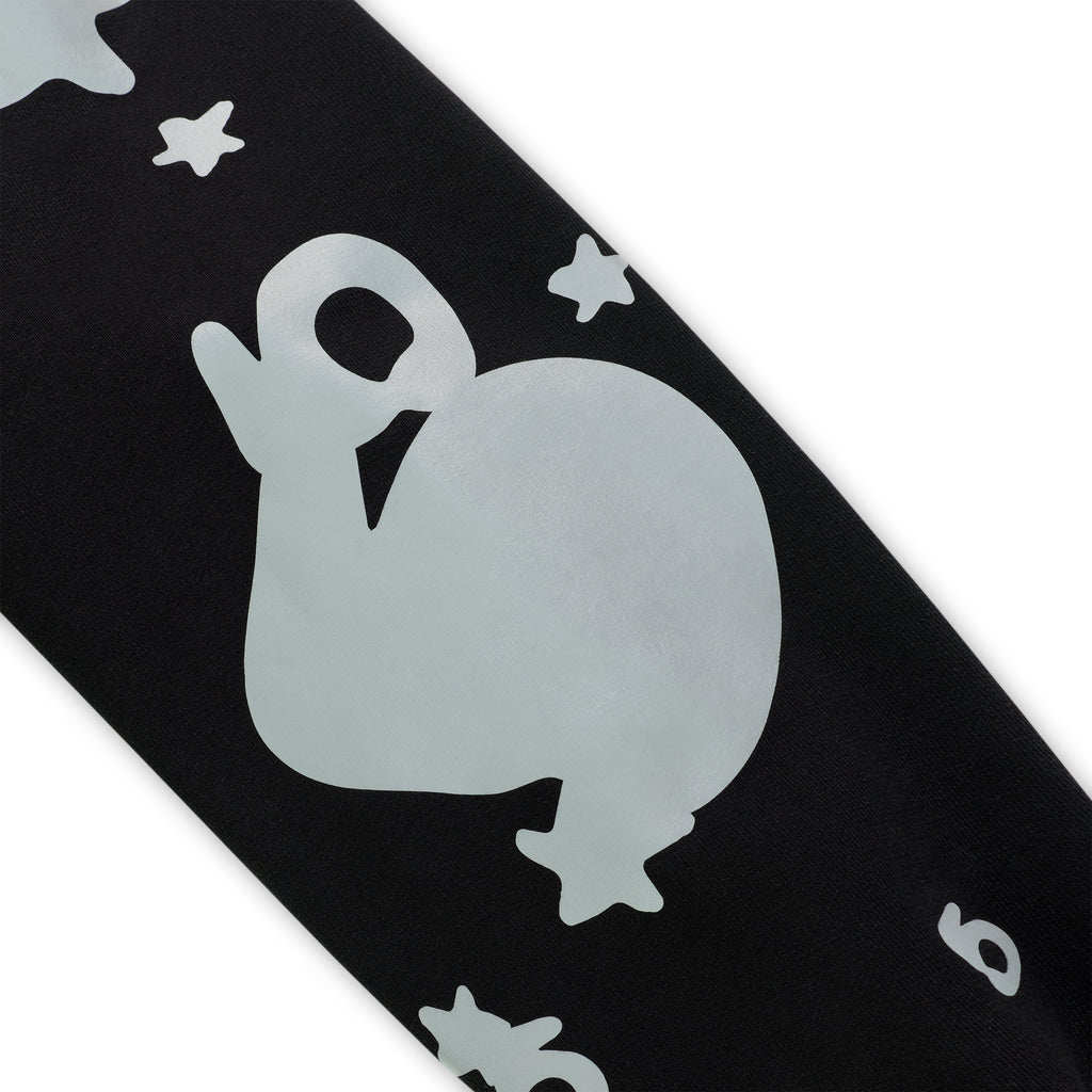 Black cotton fleece hoodie sleeve with reflective beluga whale and star print.