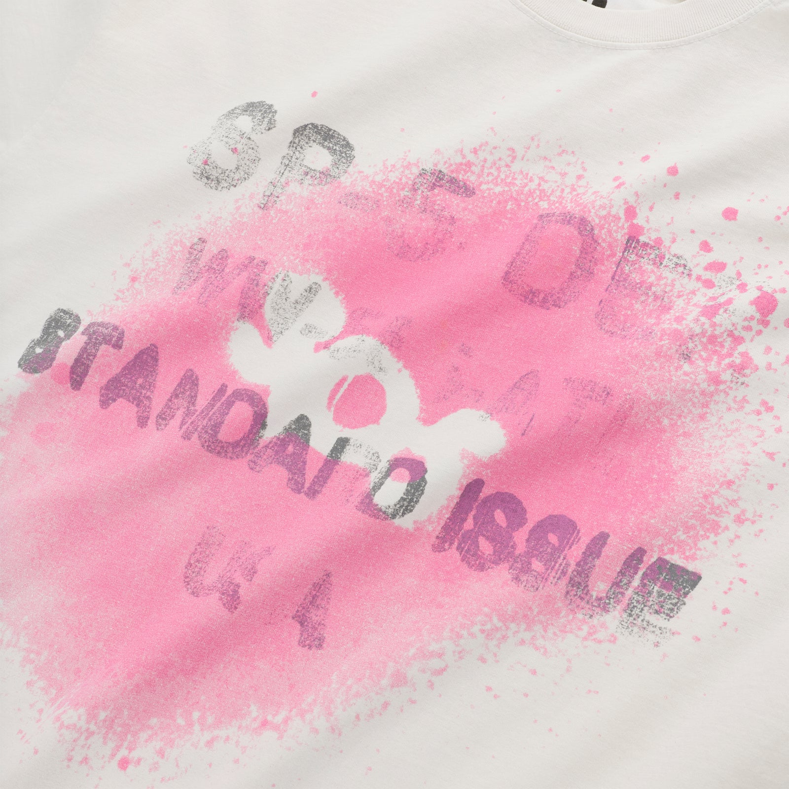White 100% cotton tee with a pink spray paint graphic and "STANDARD ISSUE" text.