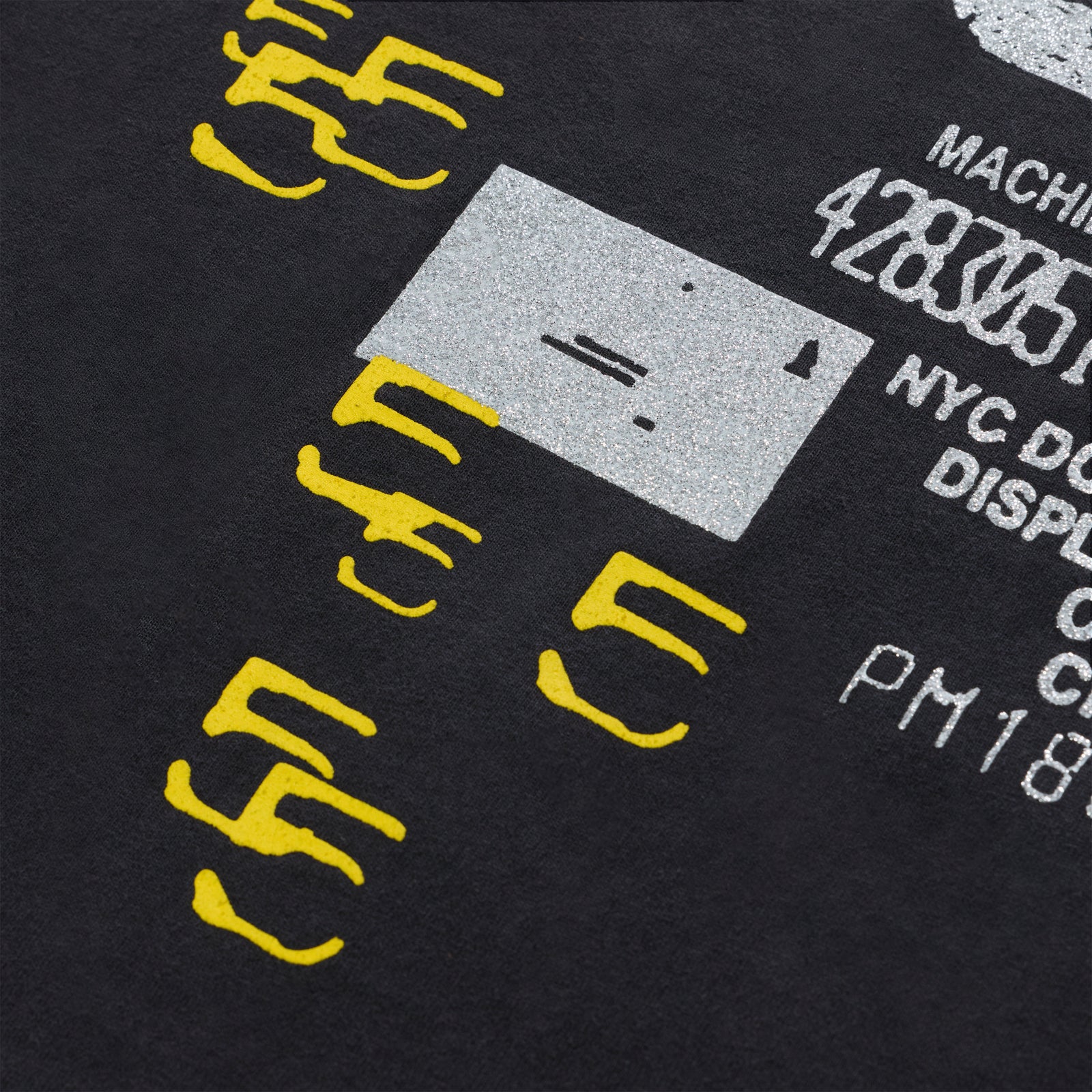 Black cotton ANNIVERSARY TEE with yellow and silver graphic print.
