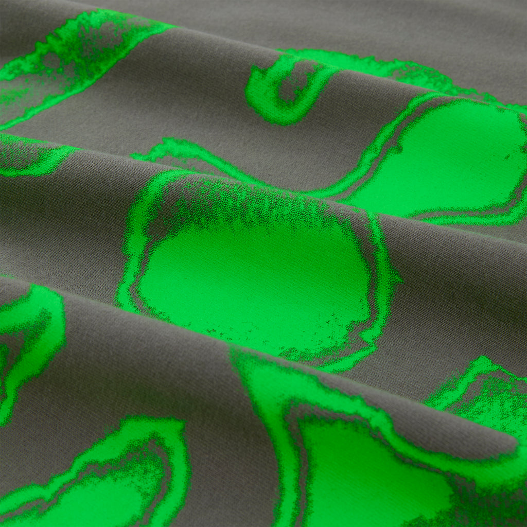 Close-up of a folded gray cotton tee with a vibrant green fingerprint graphic print.
