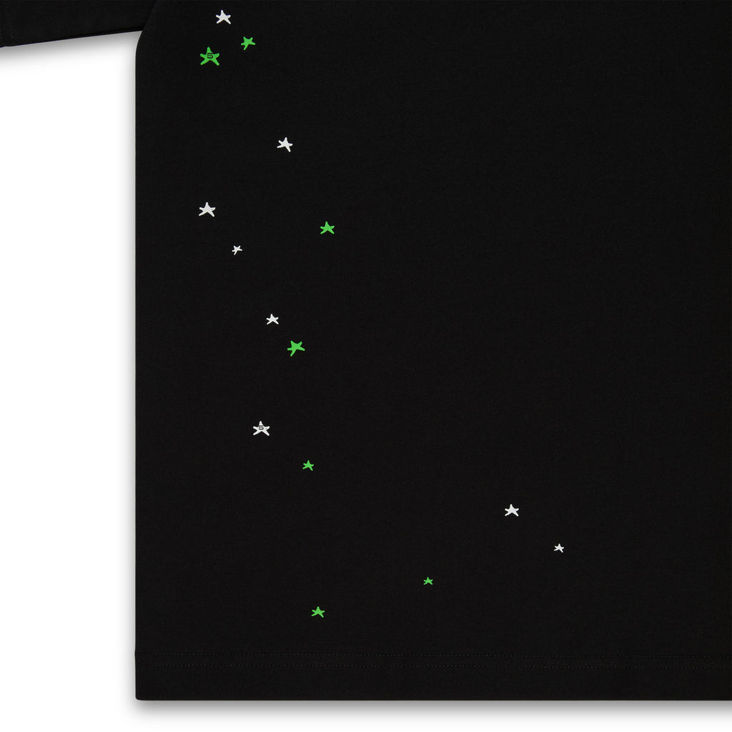 Black 100% cotton lightweight tee with scattered white and green star print.