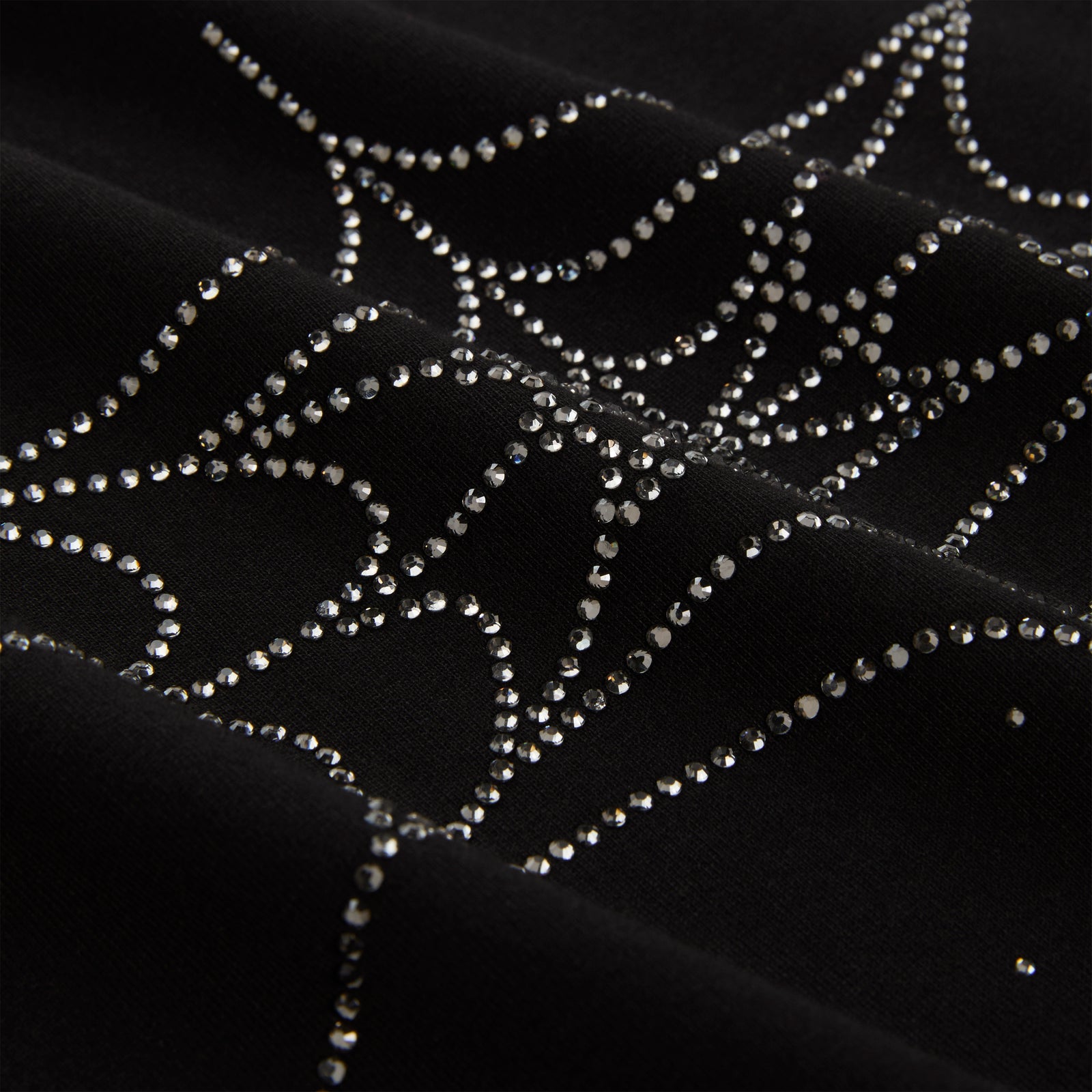 Black cotton tee with sparkling rhinestone spiderweb graphic.
