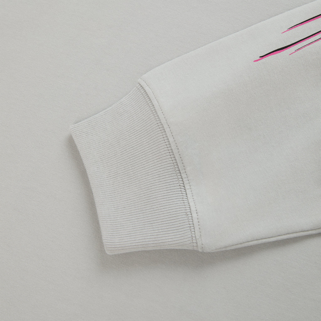 Light gray cotton long sleeve tee with ribbed cuff and pink/black graphic print detail.