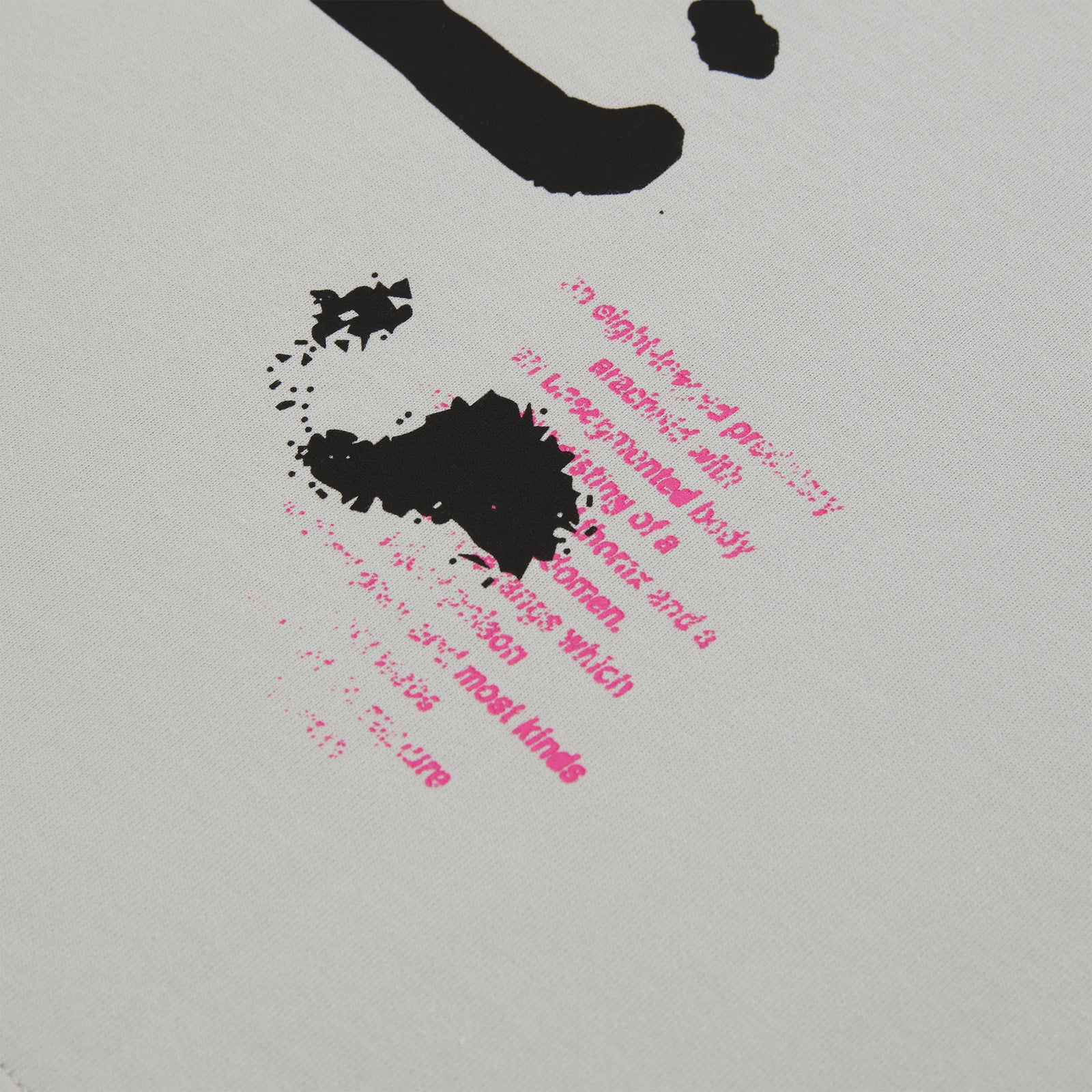 White cotton long sleeve tee with black and pink graphic print detail.