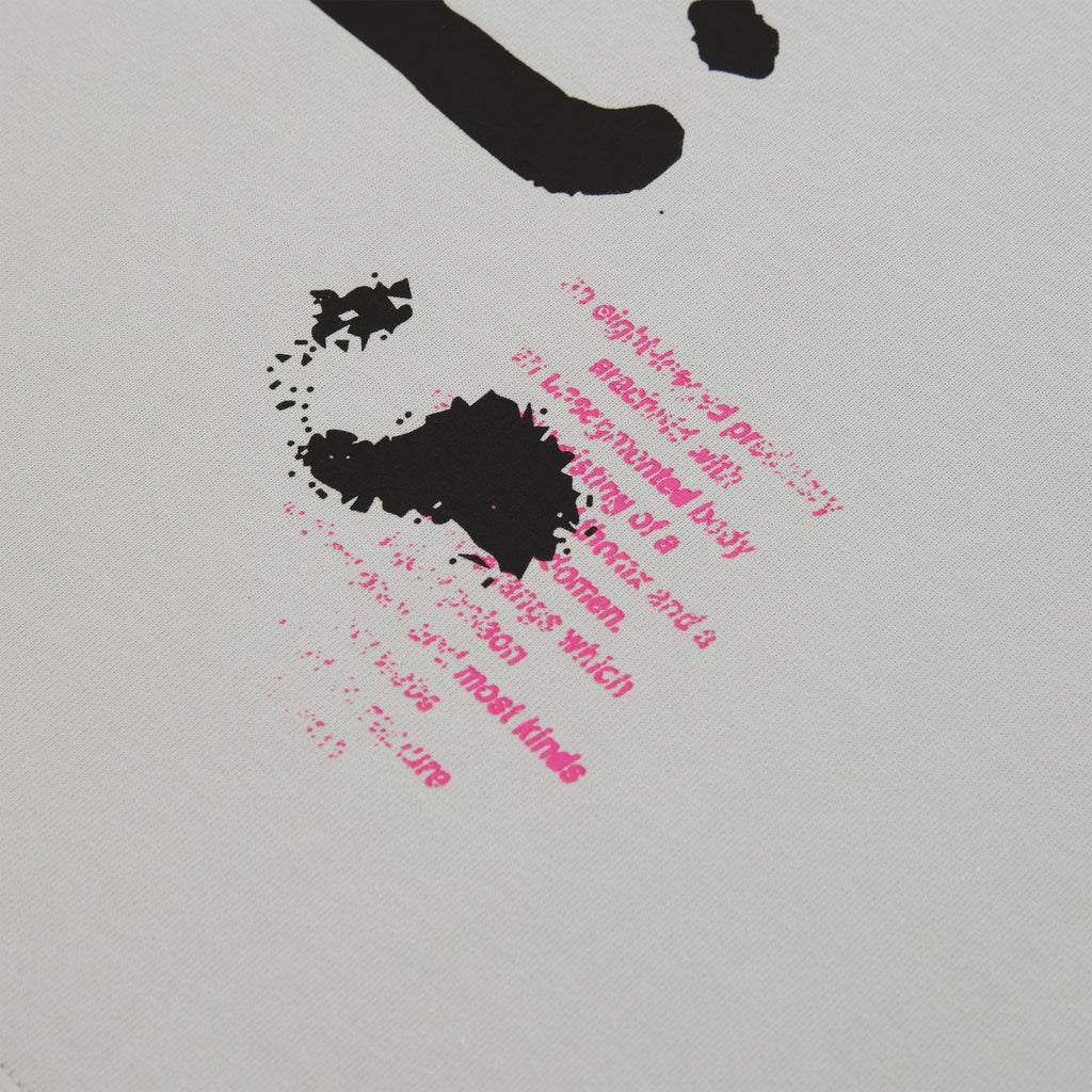 White cotton long sleeve tee with black and pink graphic print detail.