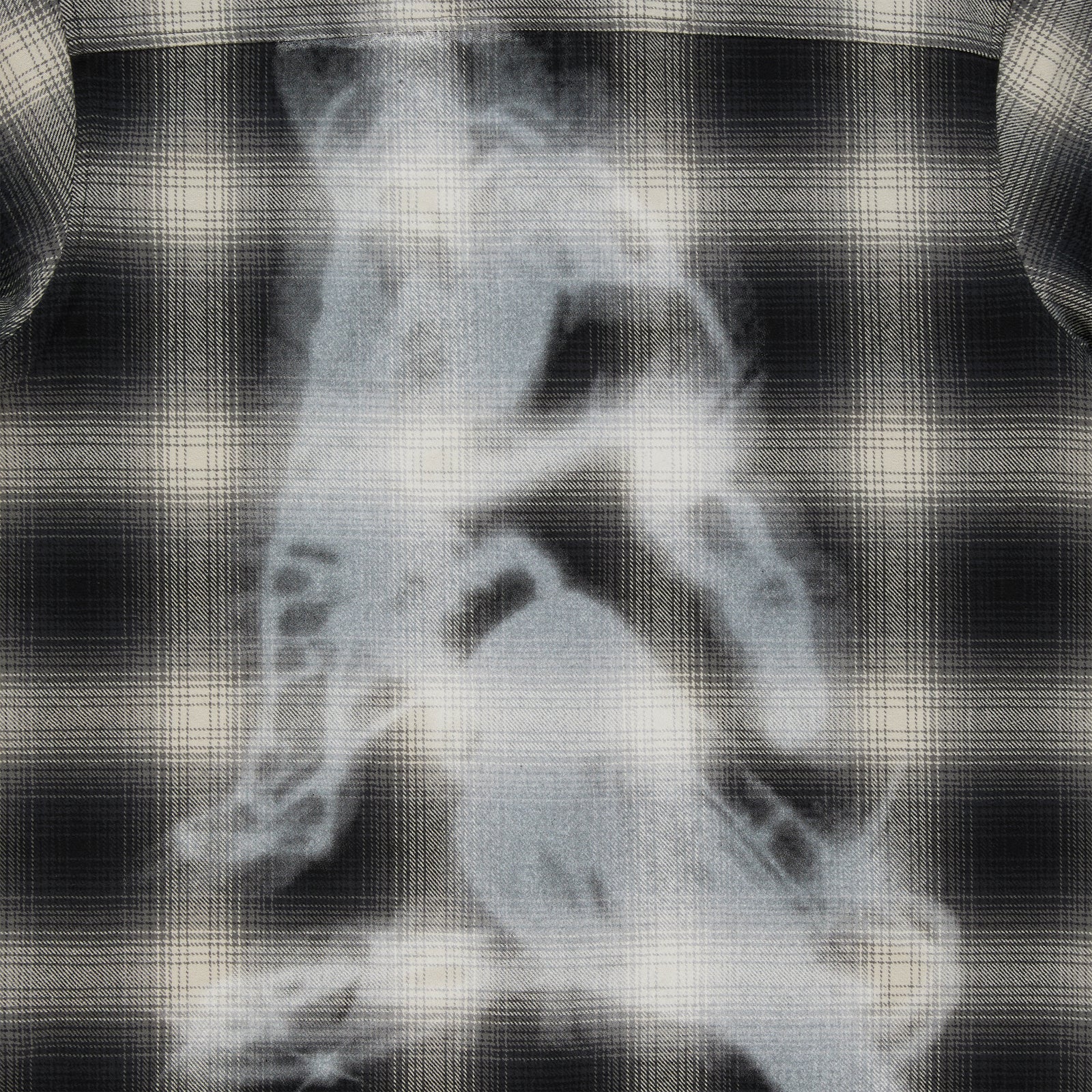 Black and cream plaid cotton flannel shirt with a faded graphic print on the back.