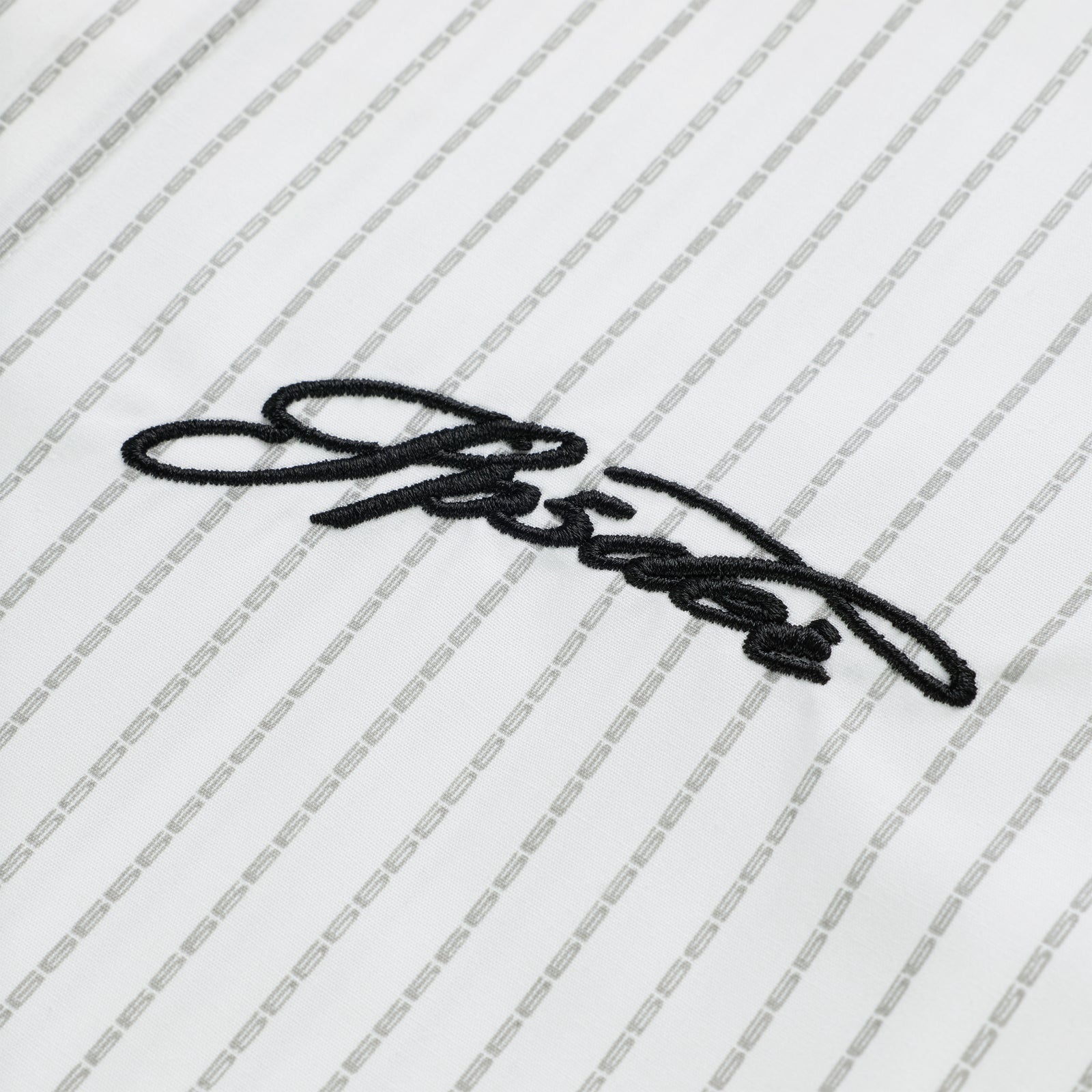 White woven cotton oxford button-down shirt with gray pinstripes and black embroidered script logo.
