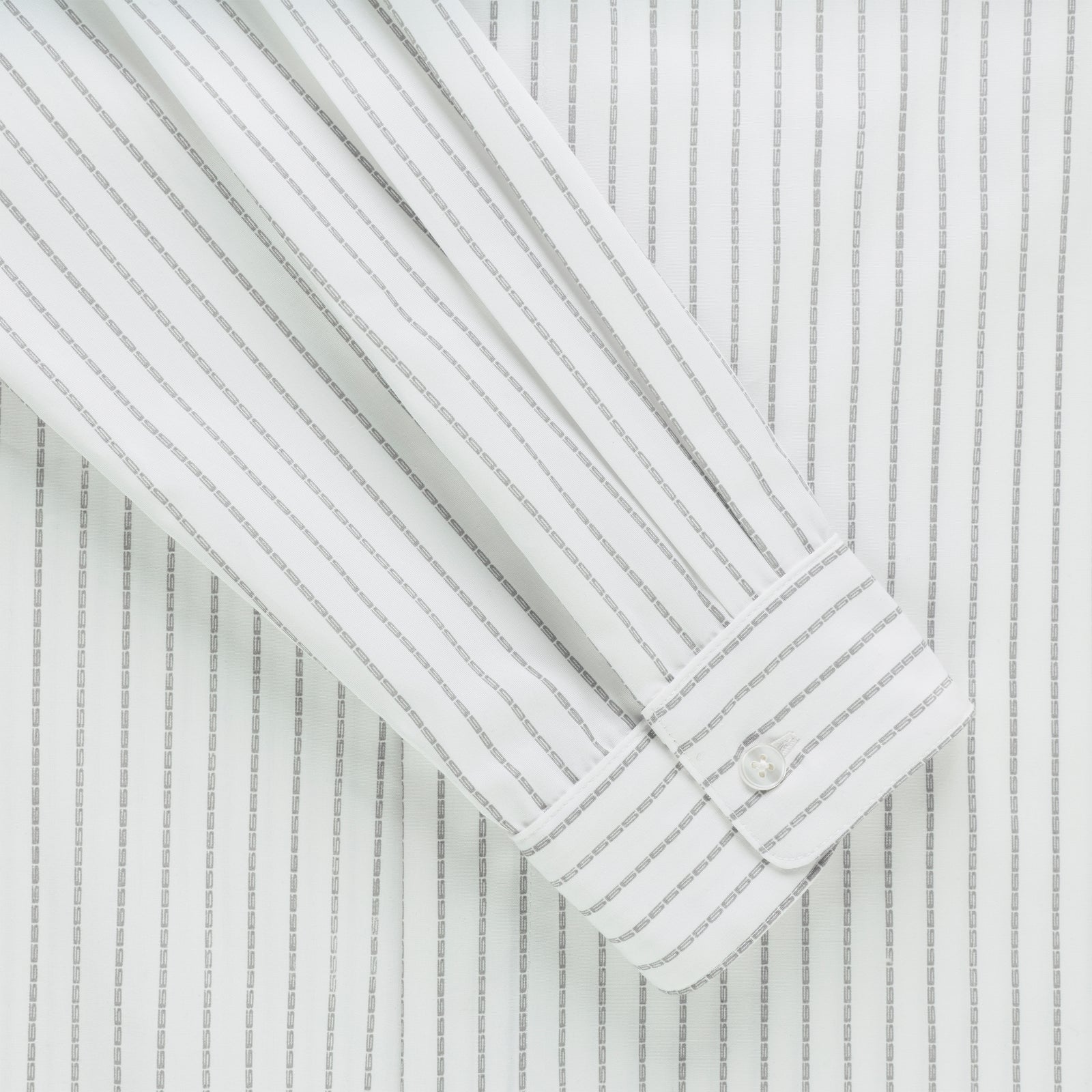 White woven cotton oxford button-down shirt with gray 5 pinstripe design and buttoned barrel cuff.