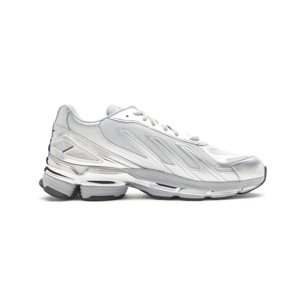 SP5DER x adidas F50 Adizero metallic silver sneaker with mesh, chrome overlays, pink accents, and a removable charm.
