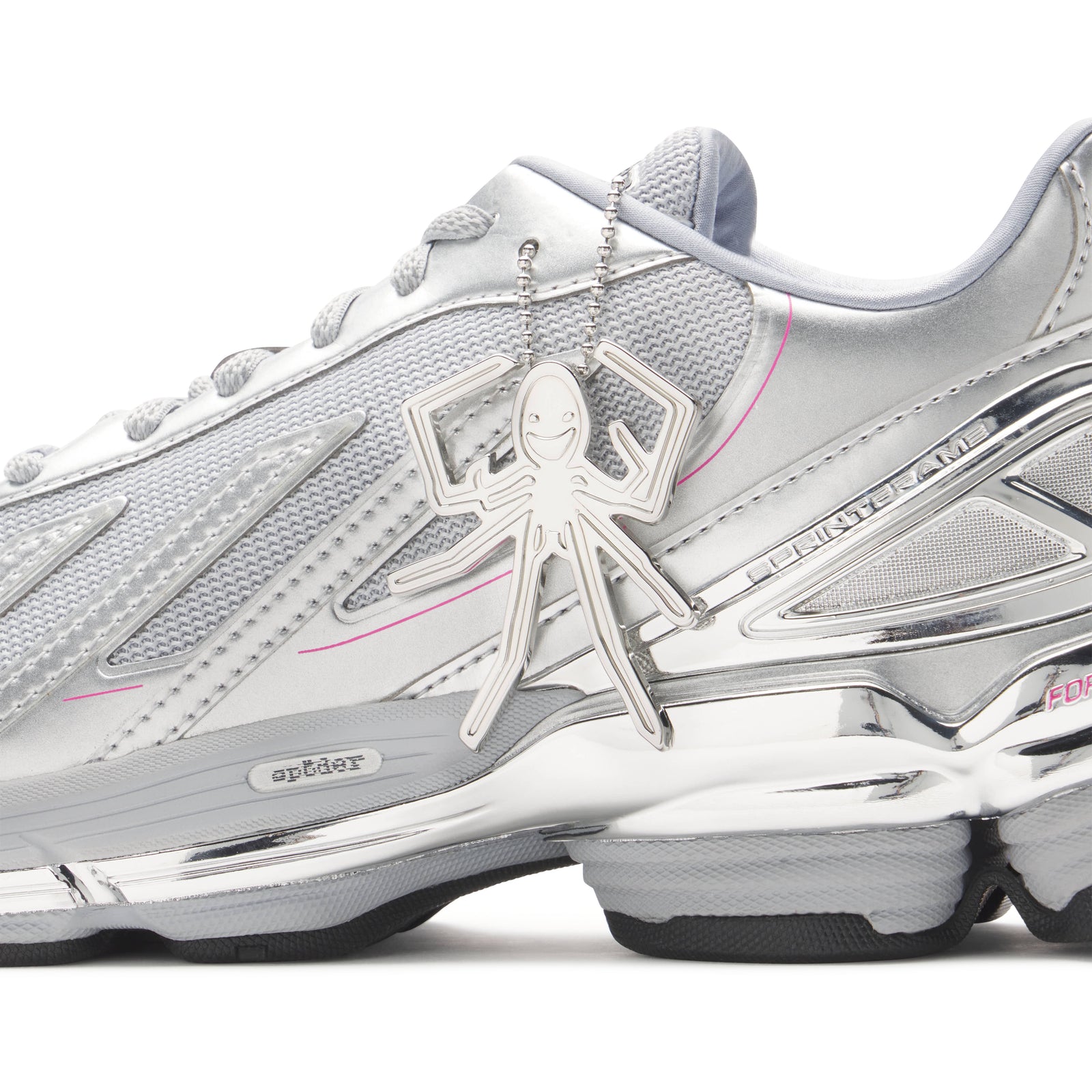 SP5DER x adidas F50 Adizero sneaker with metallic silver upper, mesh, chrome overlays, pink accents, and a spider charm.