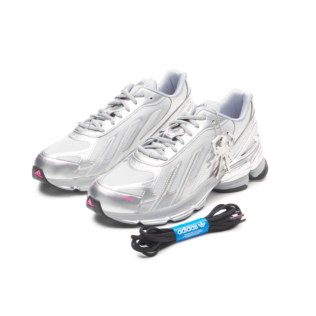 SP5DER x adidas F50 Adizero sneakers: metallic silver with pink accents, mesh upper, chrome overlays, and a removable charm.