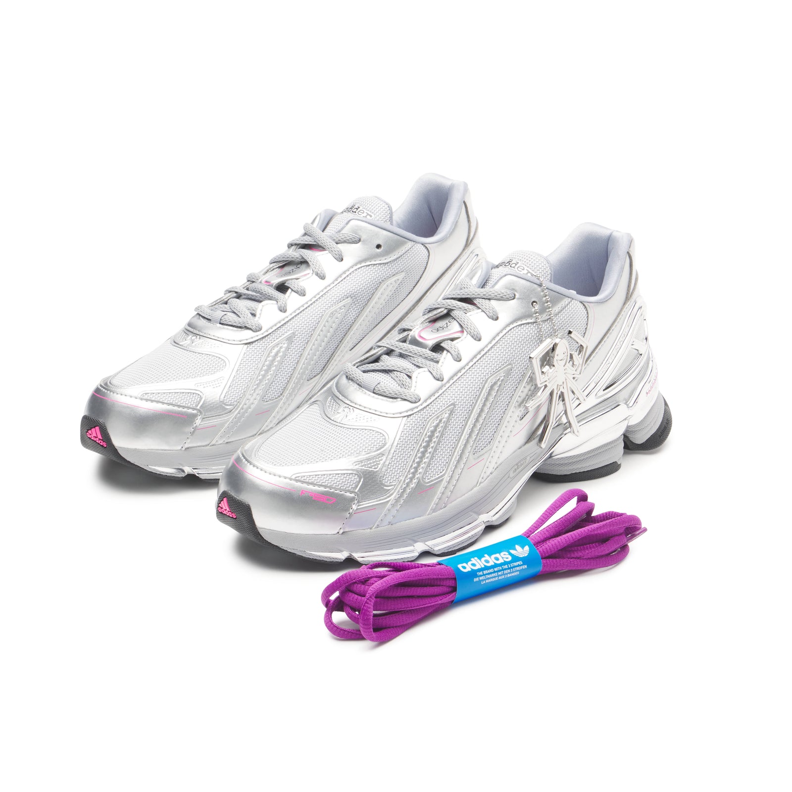 SP5DER x adidas F50 Adizero sneakers in metallic silver with pink accents, mesh, chrome overlays, and a removable charm.