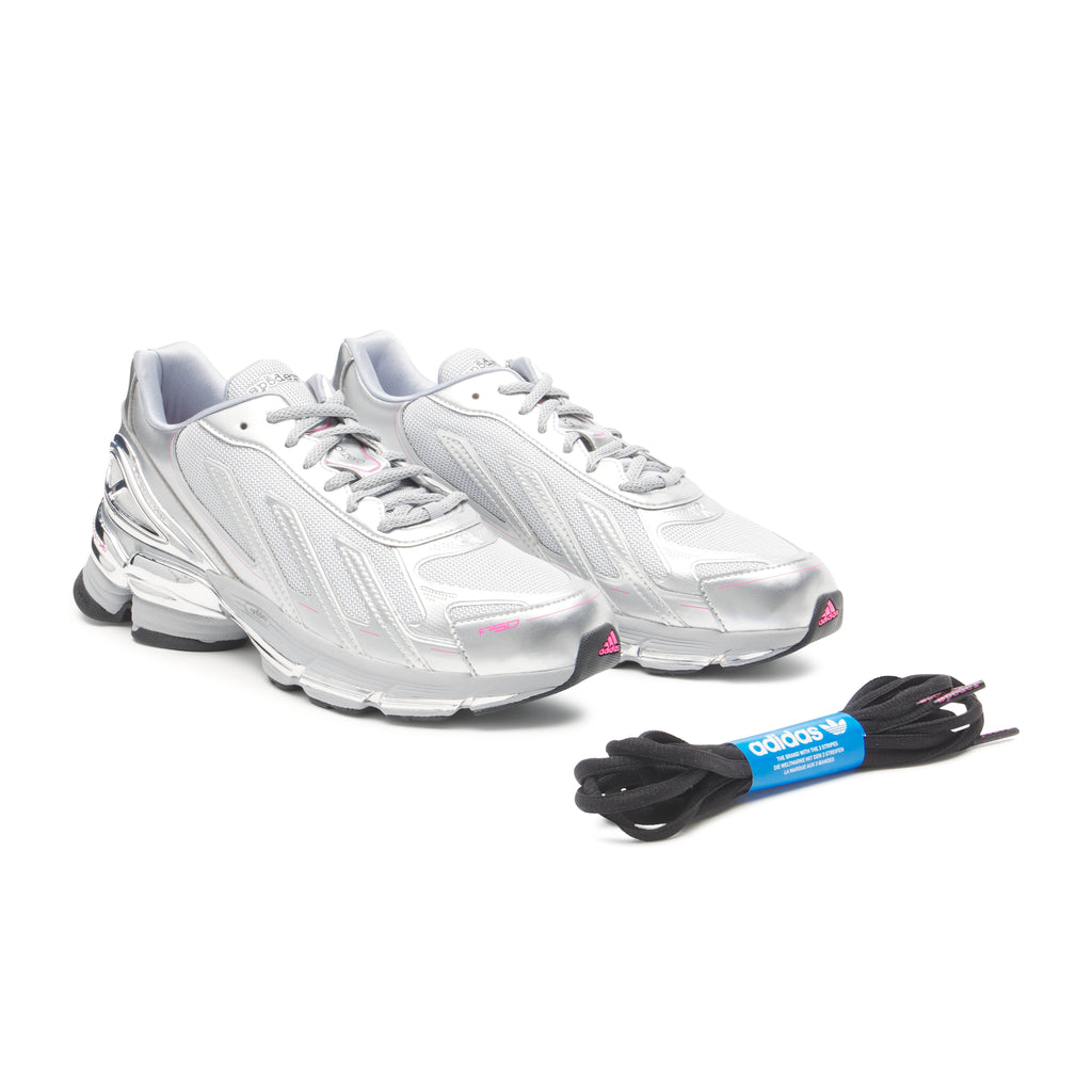 SP5DER x adidas F50 Adizero sneakers: metallic silver synthetic and mesh with pink accents, plus black laces.