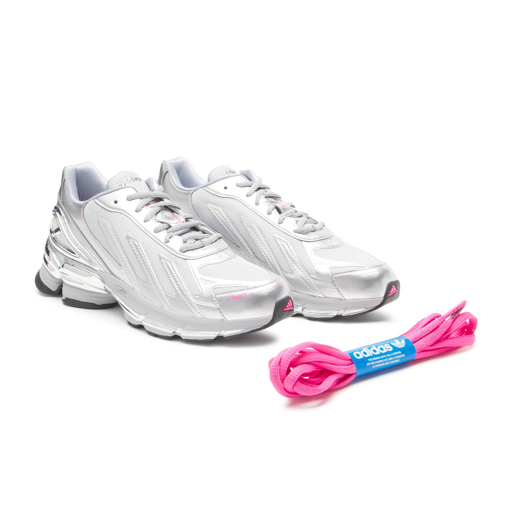 SP5DER x adidas F50 Adizero sneakers: metallic silver synthetic and mesh, pink accents, with extra pink laces.