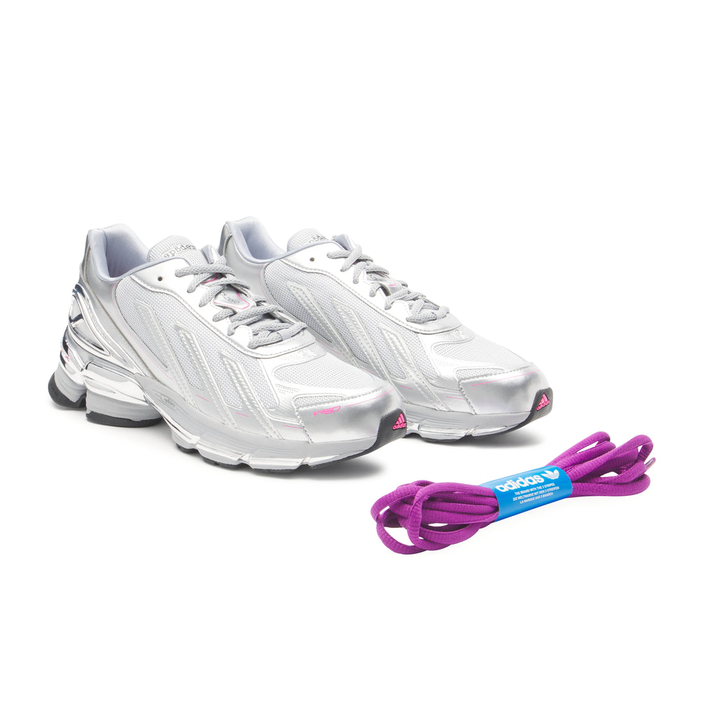 SP5DER x adidas F50 Adizero sneakers: metallic silver with pink accents, mesh upper, and extra purple laces.
