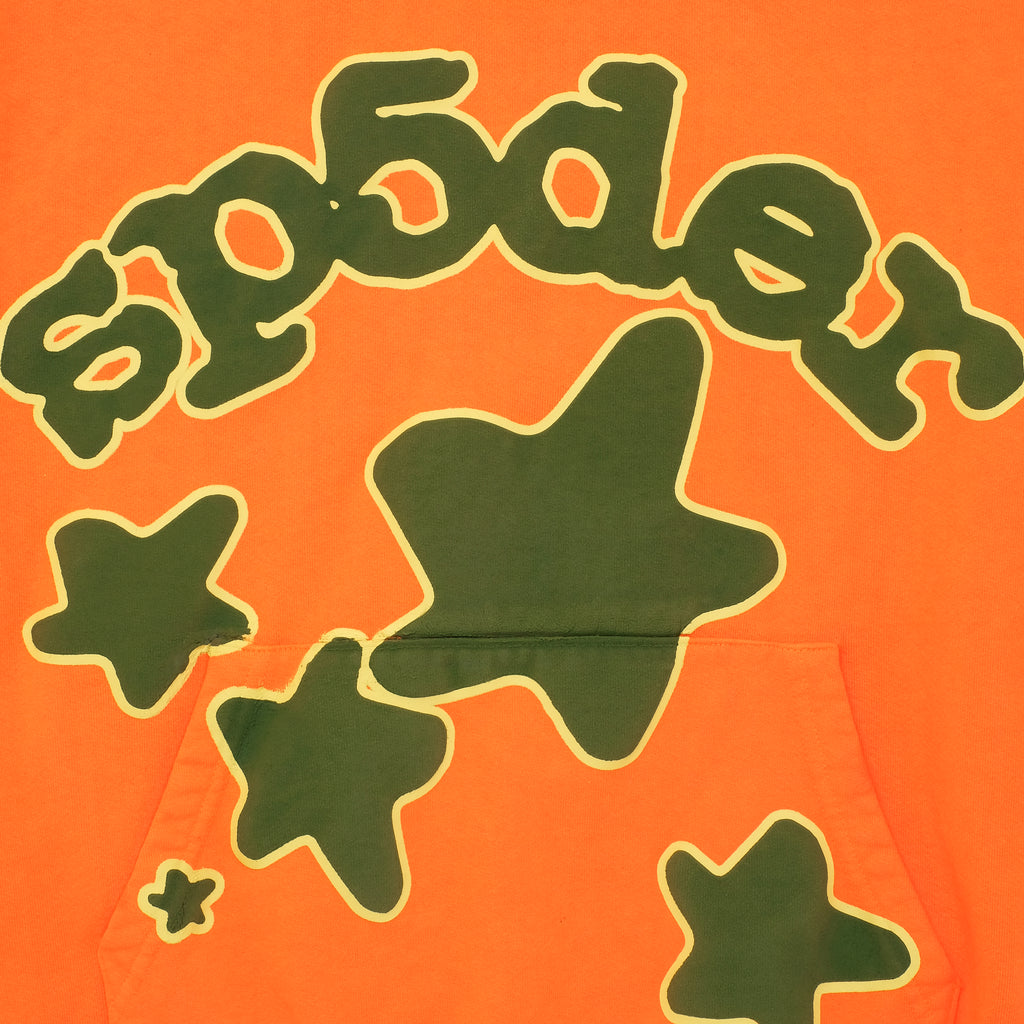 BELUGA HOODIE: Orange 23oz fleece with green 'SP5DER' puff print and star designs.