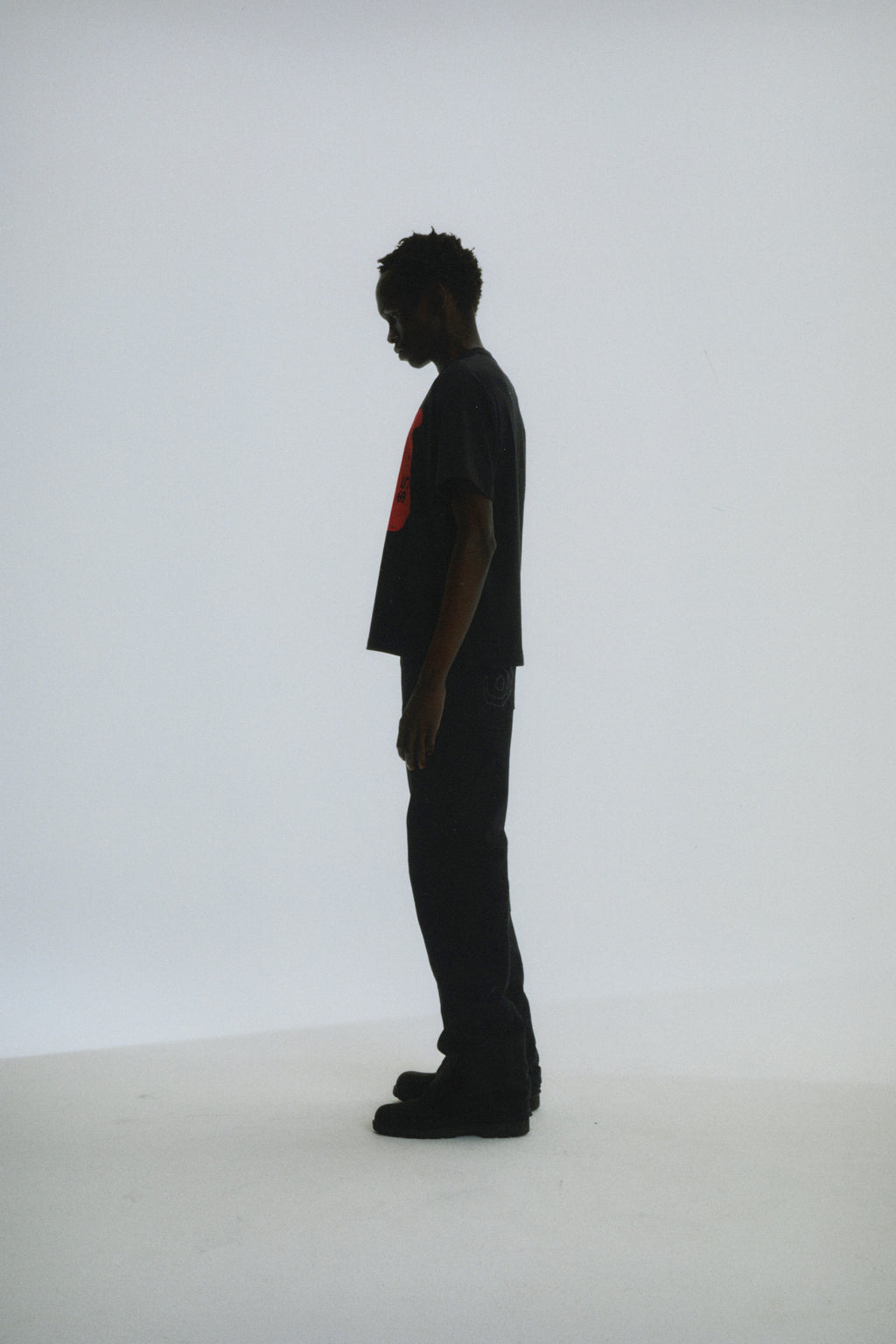 Man in black cotton Toast Tee with red graphic print, standard fit.